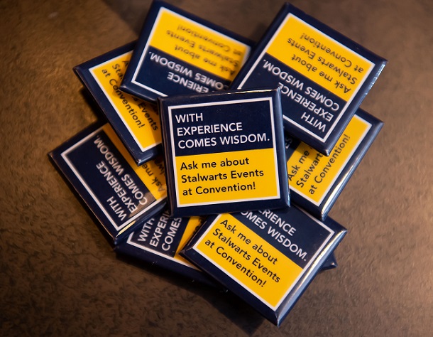 Lapel pin that says "With experience comes wisdom"