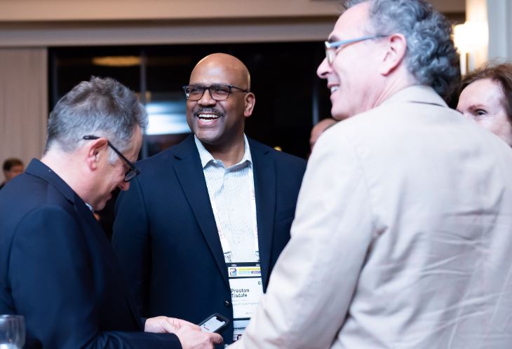 Group of attorneys laughing at networking reception.