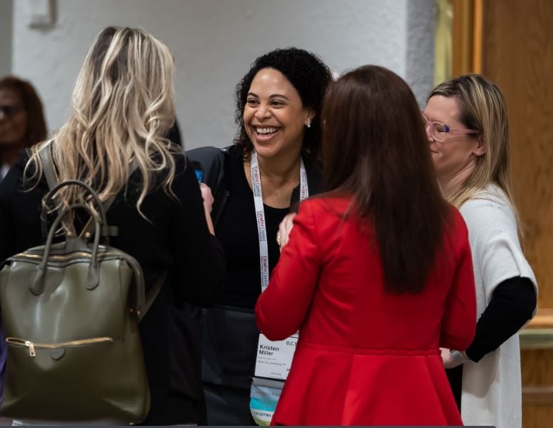 Four women laughing and talking.